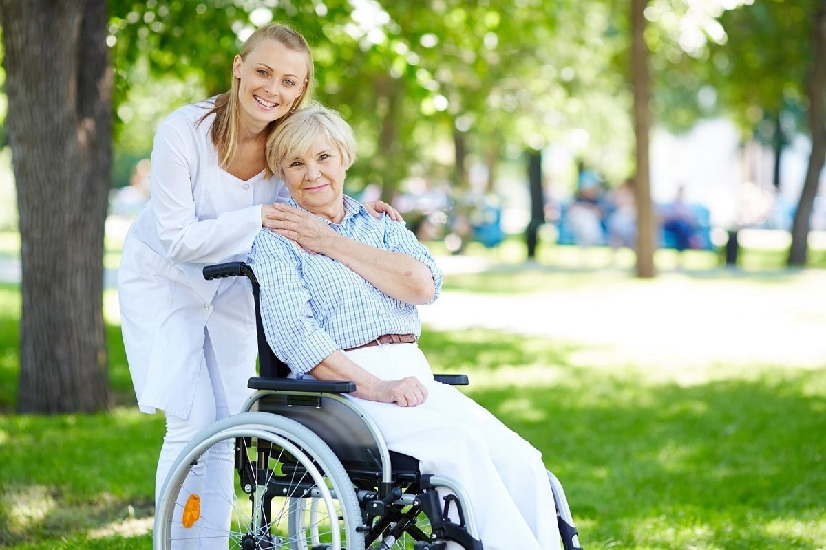 Senior woman with her caregiver outdoor