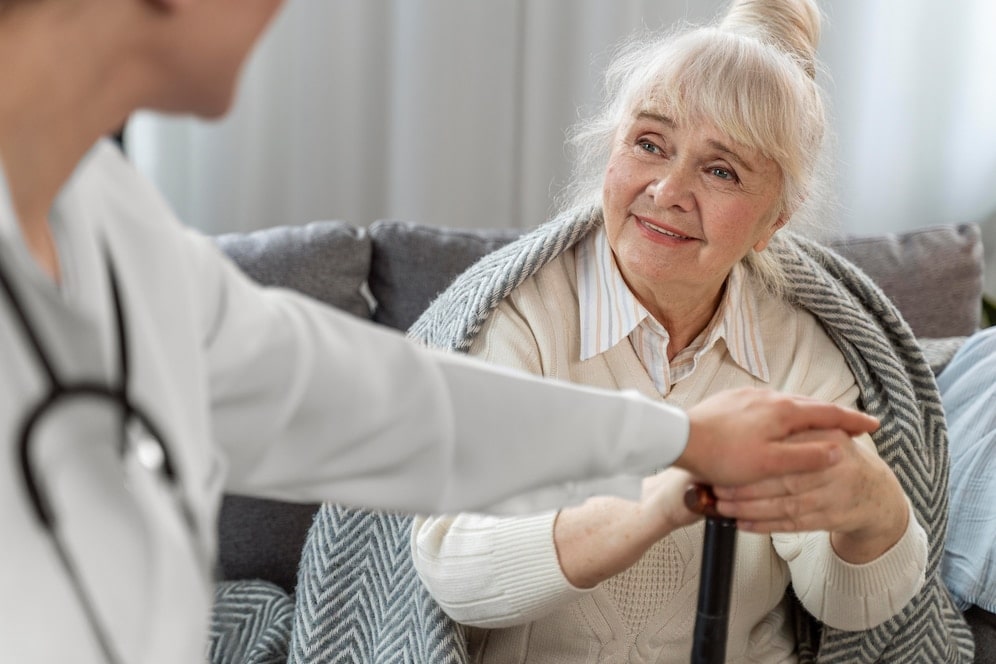 doctor taking care of senior woman at home