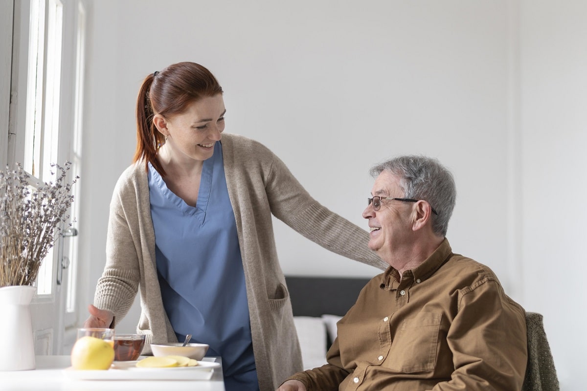 nurse taking care of a senior man at home